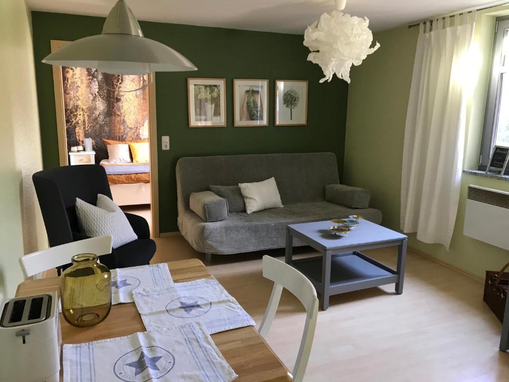 a living room with a couch and a table at Ferienwohnung Laaslich in Laaslich