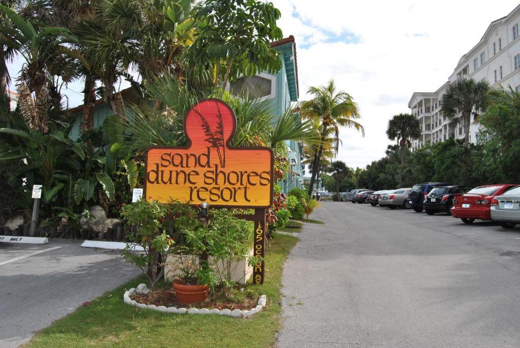 a sign for a blue shoes resort on the side of a street at Sand Dune Shores, a VRI resort in Palm Beach Shores