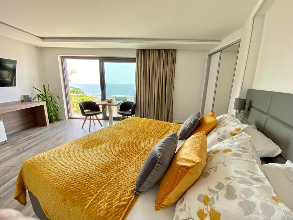 a bedroom with a bed with a view of the ocean at Villa Lenka and Mate Ivanac in Brela