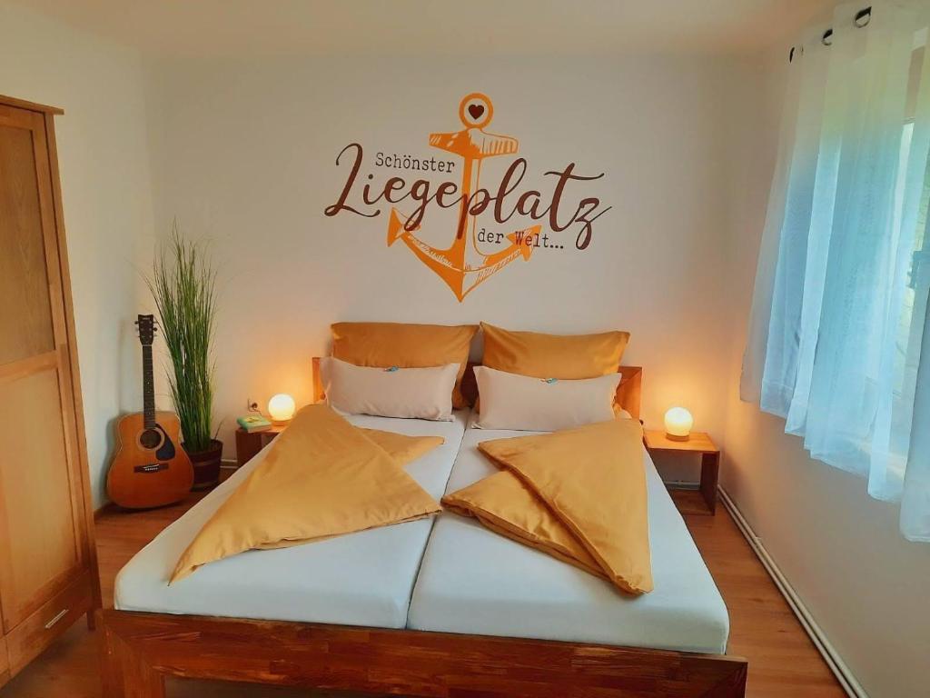 una camera da letto con un letto con un cartello nautico sul muro di Apartment Fischer mit Privatstrand a Steindorf am Ossiacher See