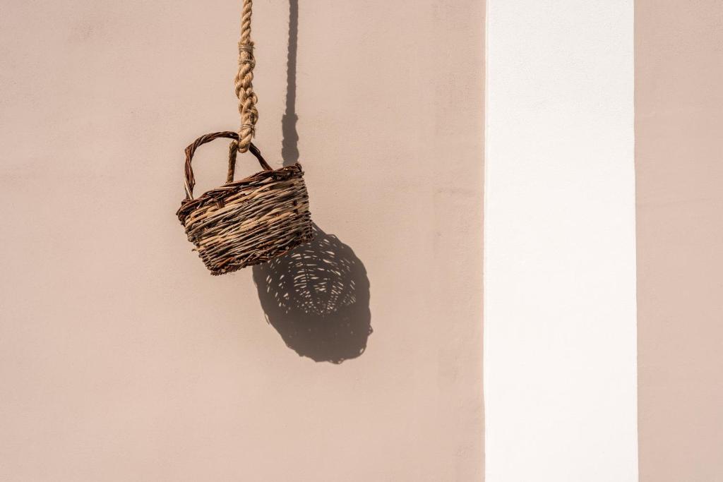 a basket hanging from a wall at Cala Cala Rooms,Restaurant & Farm Experience in Procida