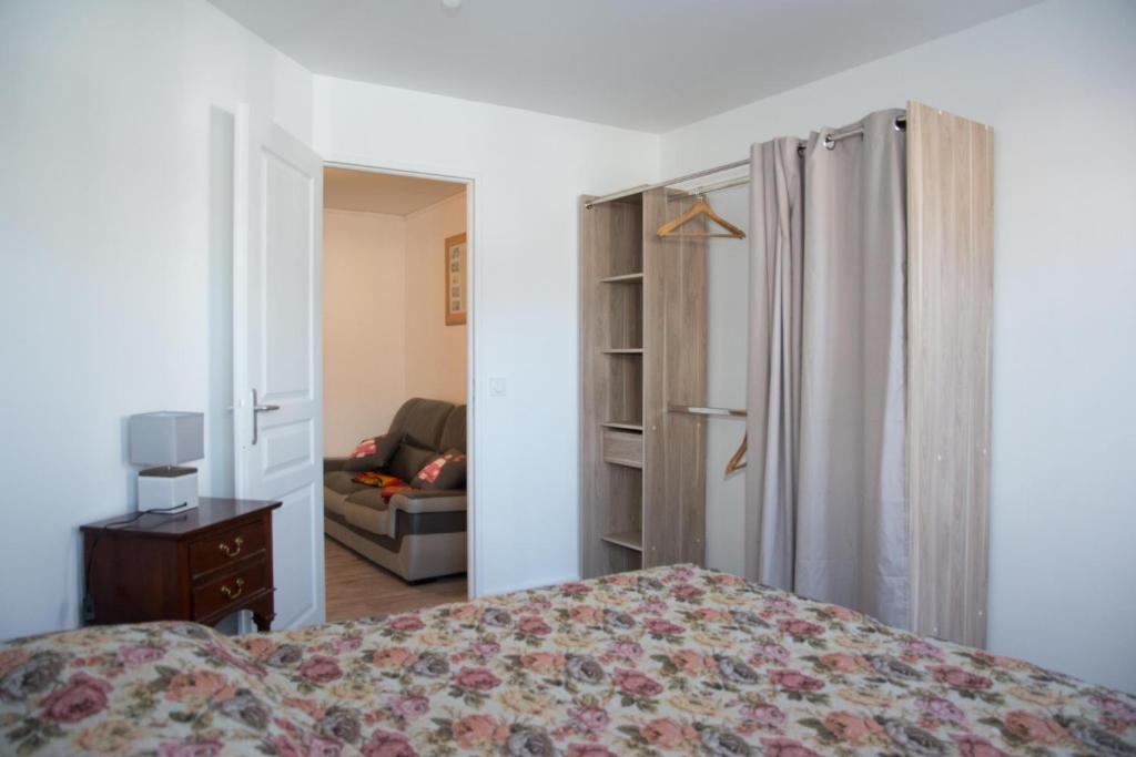 a bedroom with a bed and a living room at Damville Centre in Damville