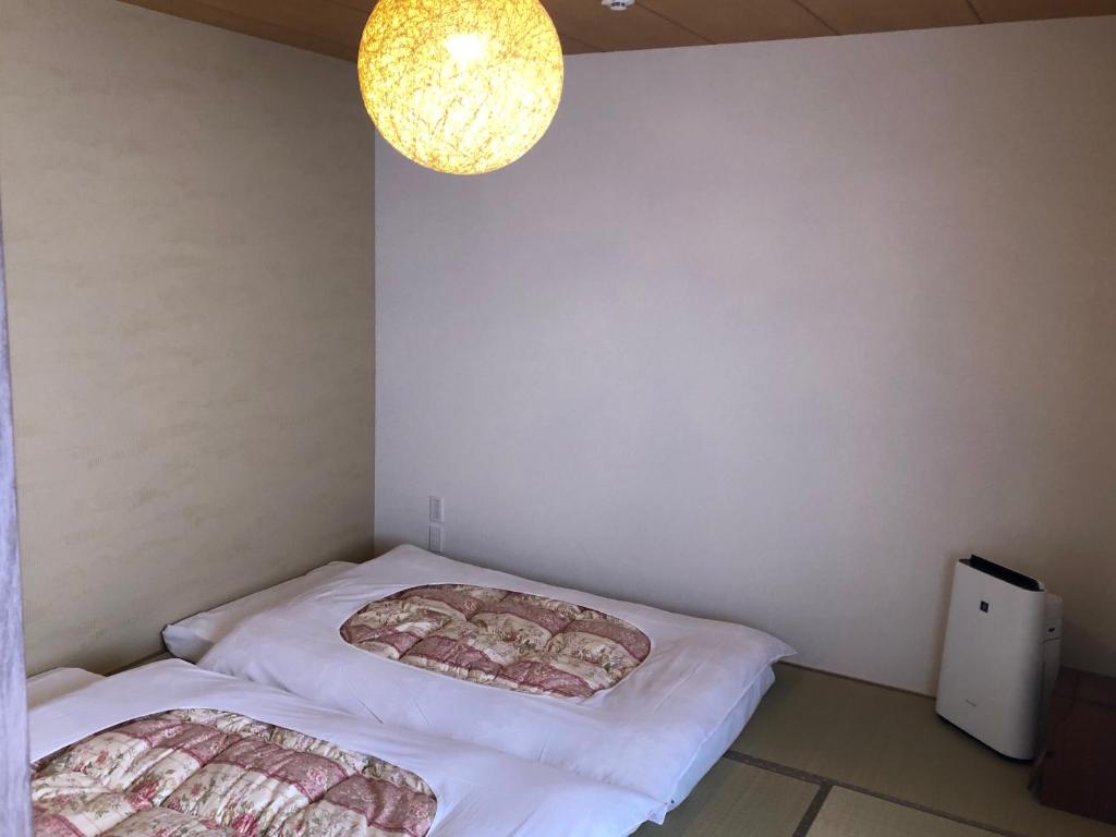 Postel nebo postele na pokoji v ubytování 民宿 和屋