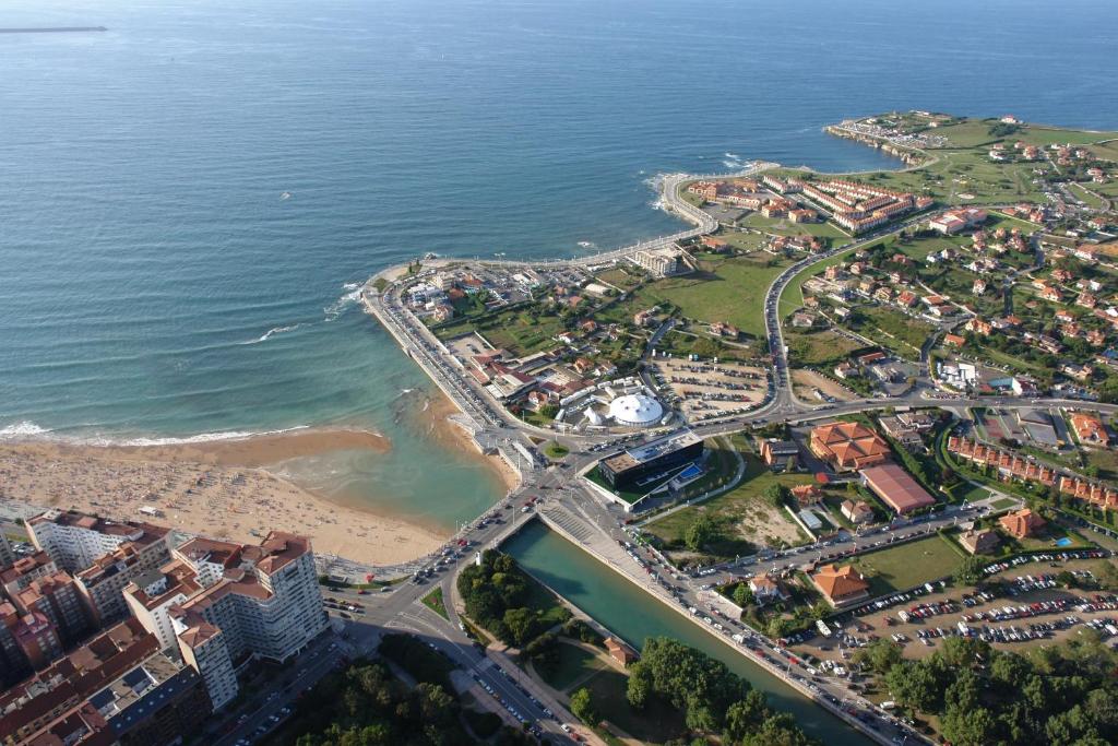 an aerial view of a city and the beach at Hotel Begoña Park in Gijón