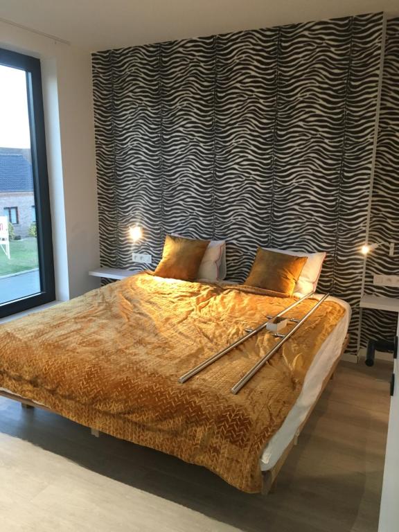 a bedroom with a large bed and a large window at Gods Heide in Hasselt