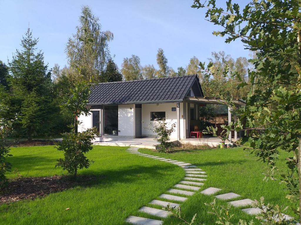 een huis met een loopbrug voor een tuin bij Mazury domek całoroczny Pelnik gm Ostróda jezioro las in Pelnik