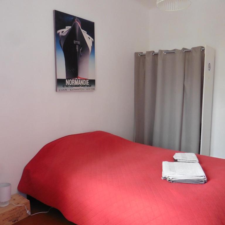 a bedroom with a red bed with a poster on the wall at Villa Zola in Aix-en-Provence
