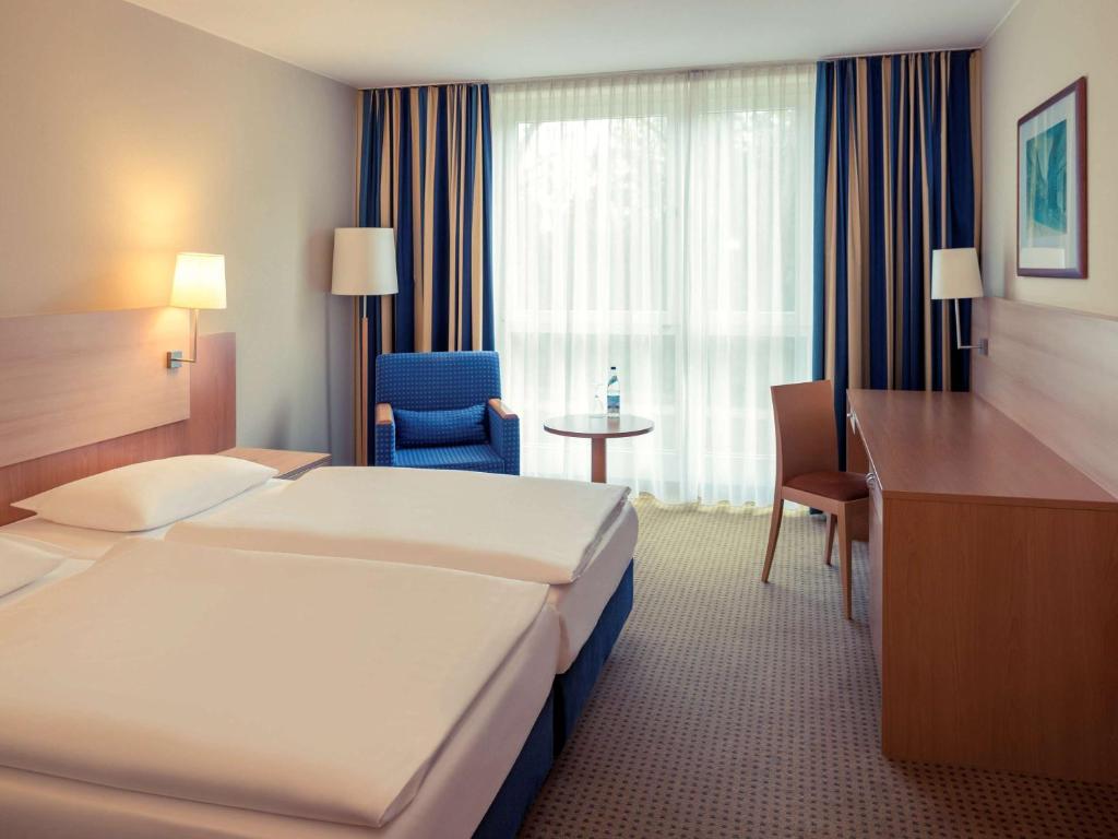 Postel nebo postele na pokoji v ubytování Mercure Hotel Schweinfurt Maininsel