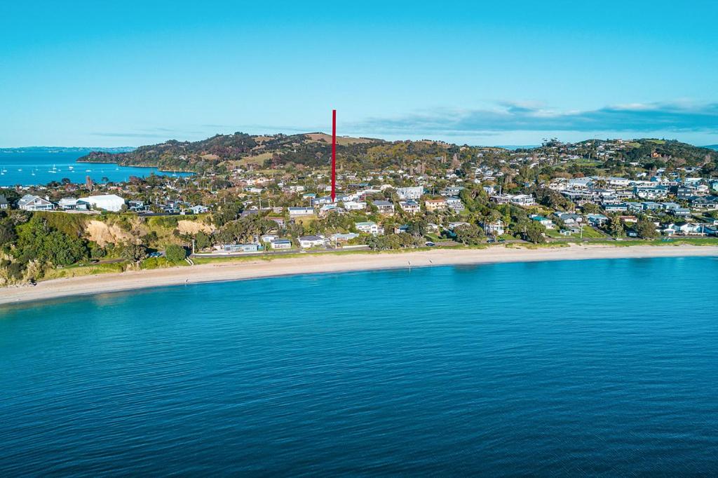 an aerial view of a beach with a red pole at Oneroa Bay Villa Waiheke in Oneroa