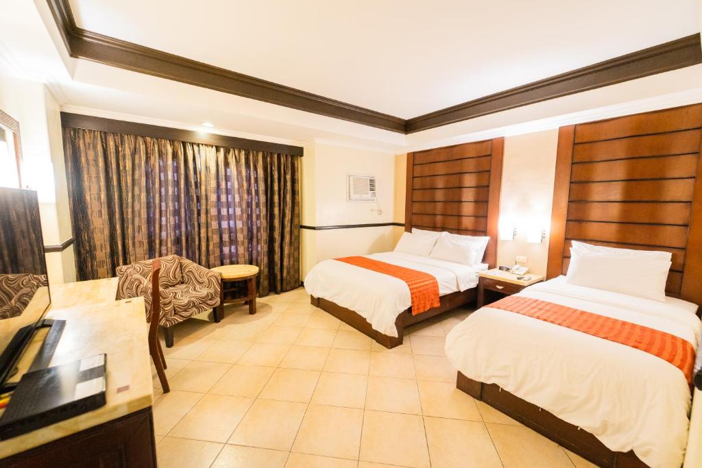 Postel nebo postele na pokoji v ubytování MO2 Westown Hotel Iloilo