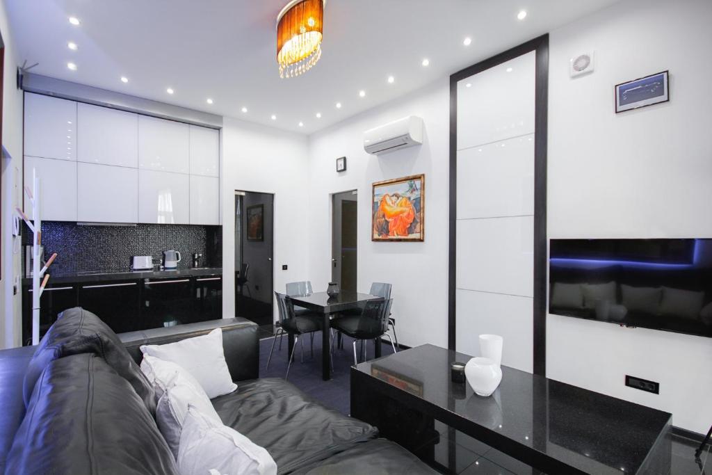a living room with a couch and a table at Panoramic 1-BR apartment in the heart of Odessa in Odesa