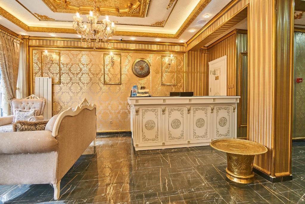 Sultan Suleyman Palace Hotel & Spa في إسطنبول: غرفة معيشة بها أريكة وطاولة وثريا