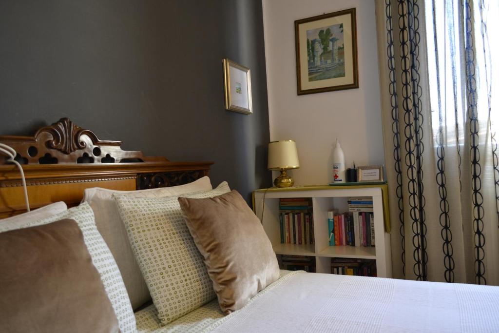 a bedroom with a bed and a book shelf at Osimo B&B in Osimo