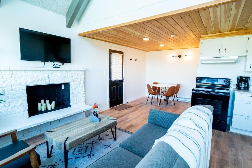 a living room with a couch and a fireplace at Tidal House #10 - Ocean Shores Chalet in Ocean Shores