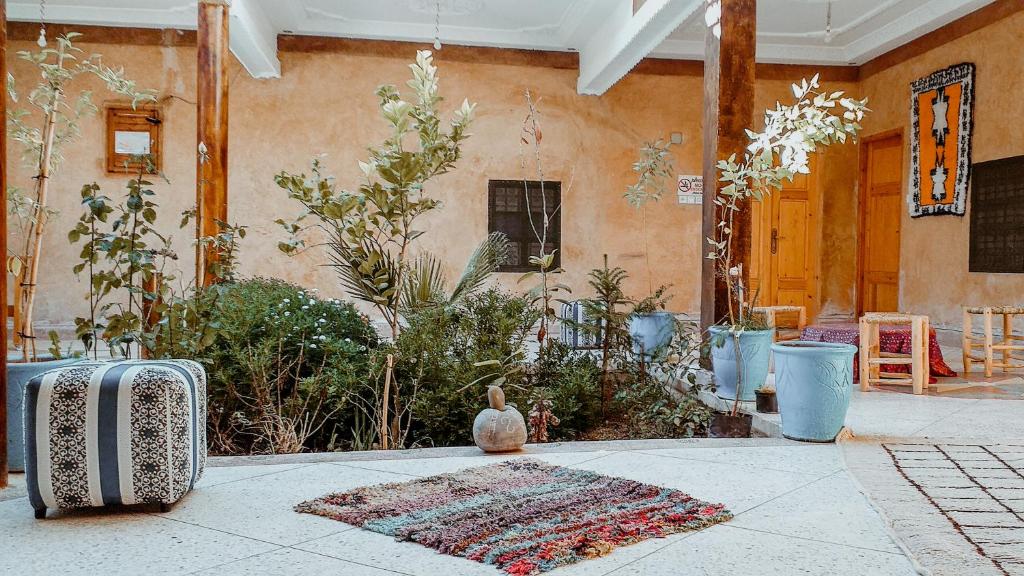 a house with a rug on the floor of a patio at ZEN ECOLODGE in Tighli