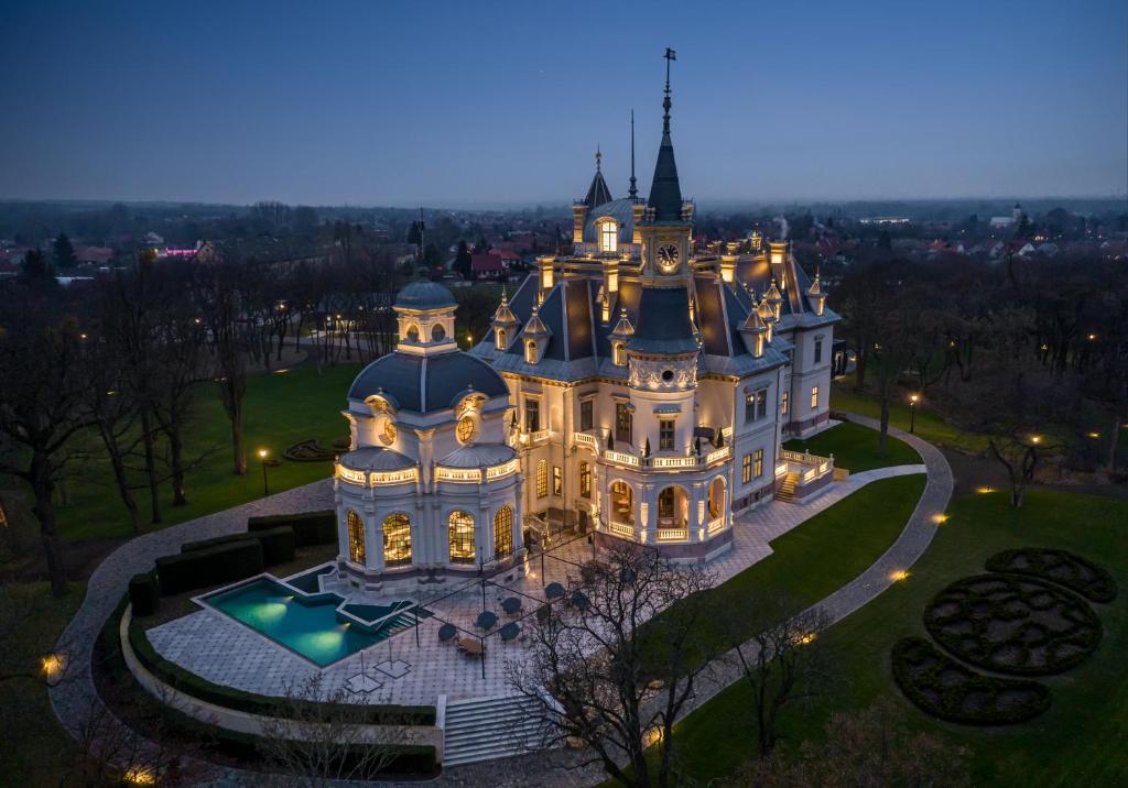 an aerial view of a castle at night at BOTANIQ Castle of Tura - Small Luxury Hotels of the World in Tura