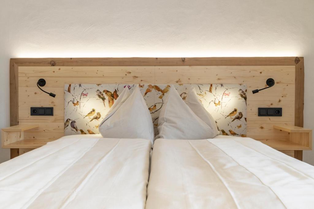 Postel nebo postele na pokoji v ubytování Hotel Winkler-Tuschnig