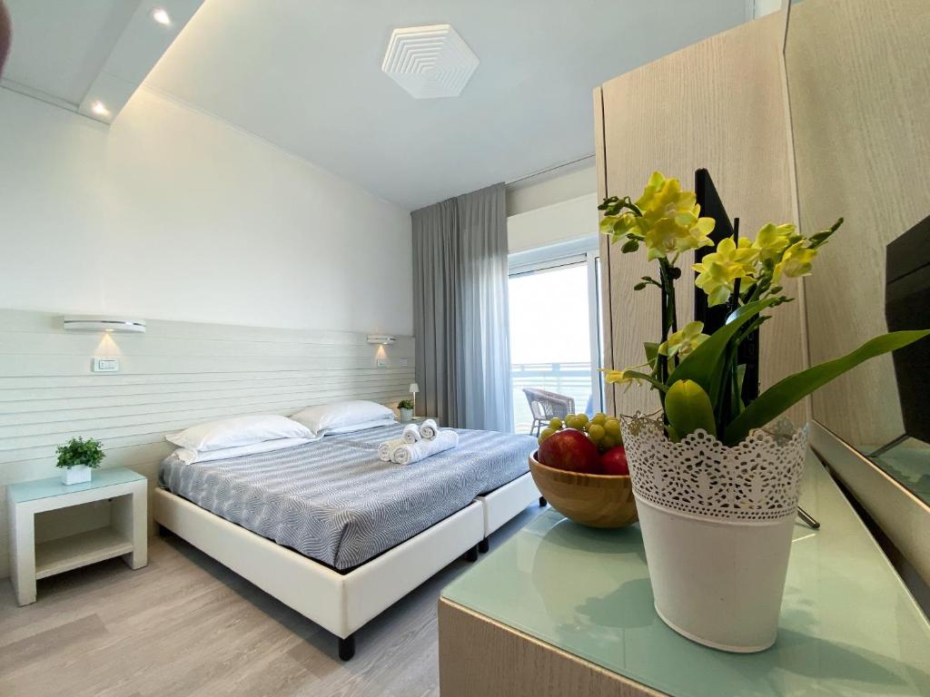 A bed or beds in a room at Club Hotel