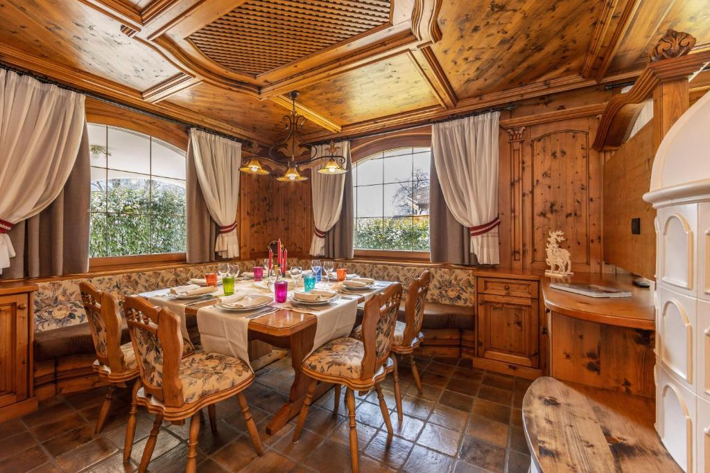 a dining room with a table and chairs at Chalet Mountain Plaza - Apt Garden in Pinzolo