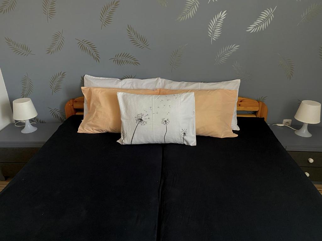 A bed or beds in a room at Bóbita Apartman