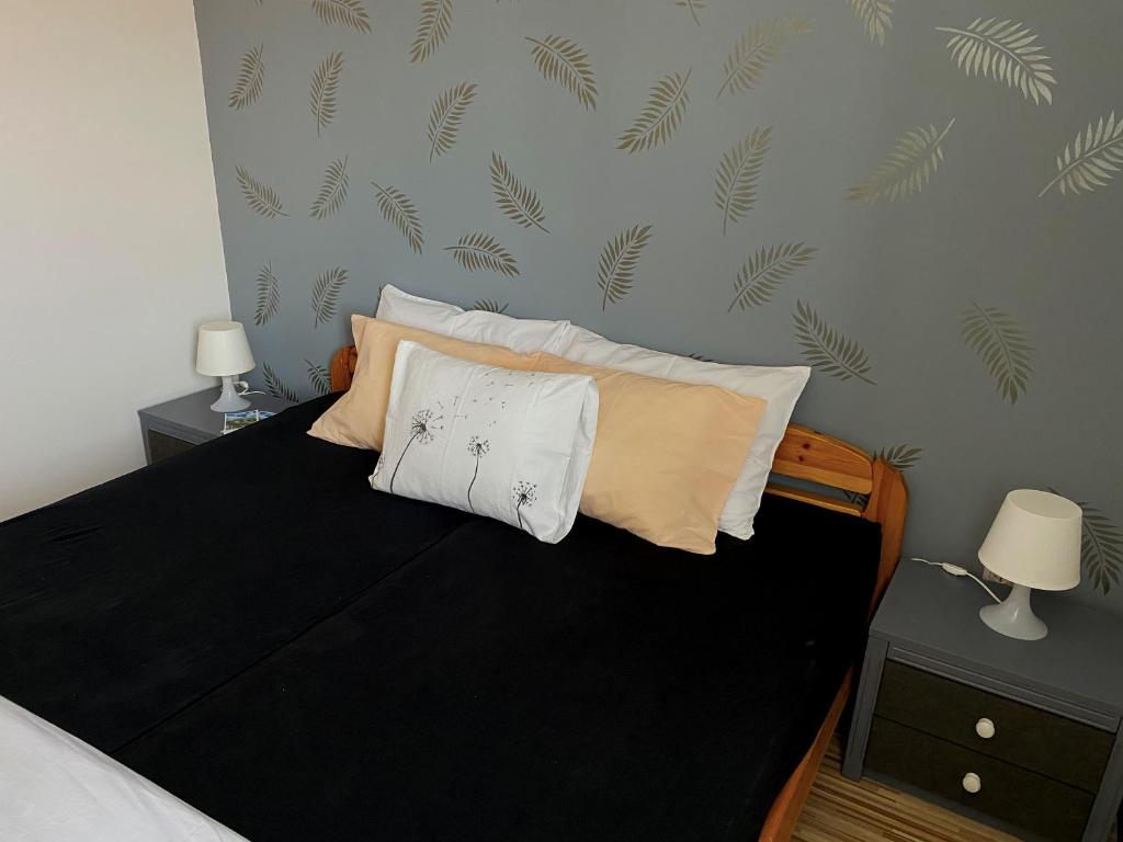 A bed or beds in a room at Bóbita Apartman