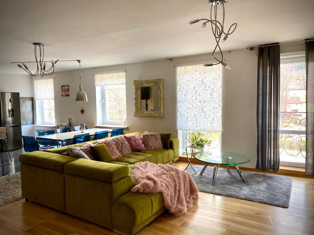 a living room with a couch and a table at Apartament Monroe in Ustrzyki Dolne