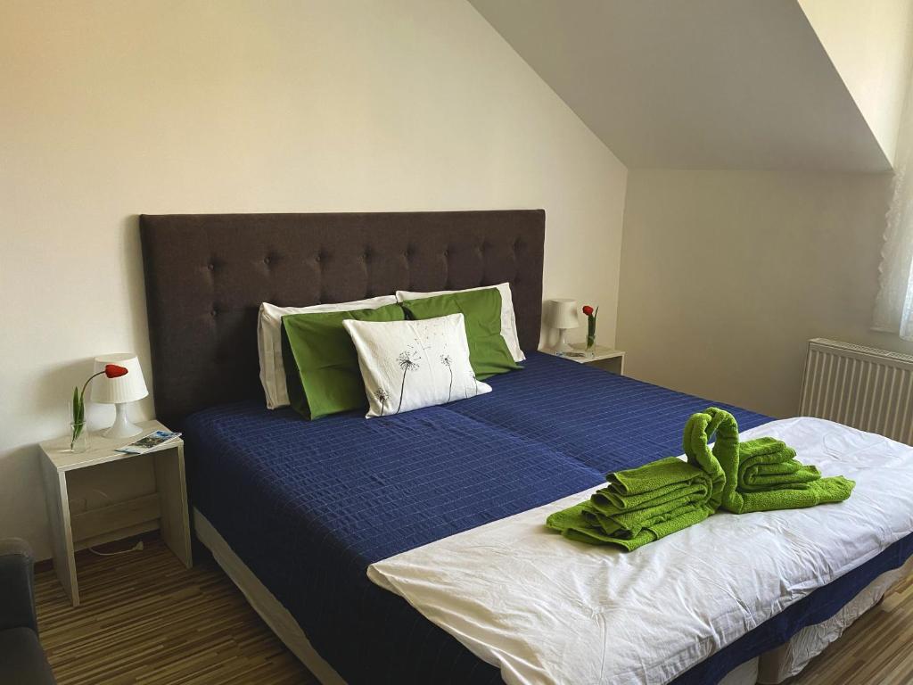 A bed or beds in a room at Bóbita Apartman