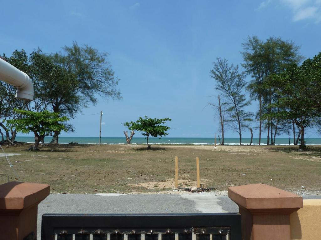 a view of a beach with trees and the ocean at Cempaka Beach Resort in Kuantan