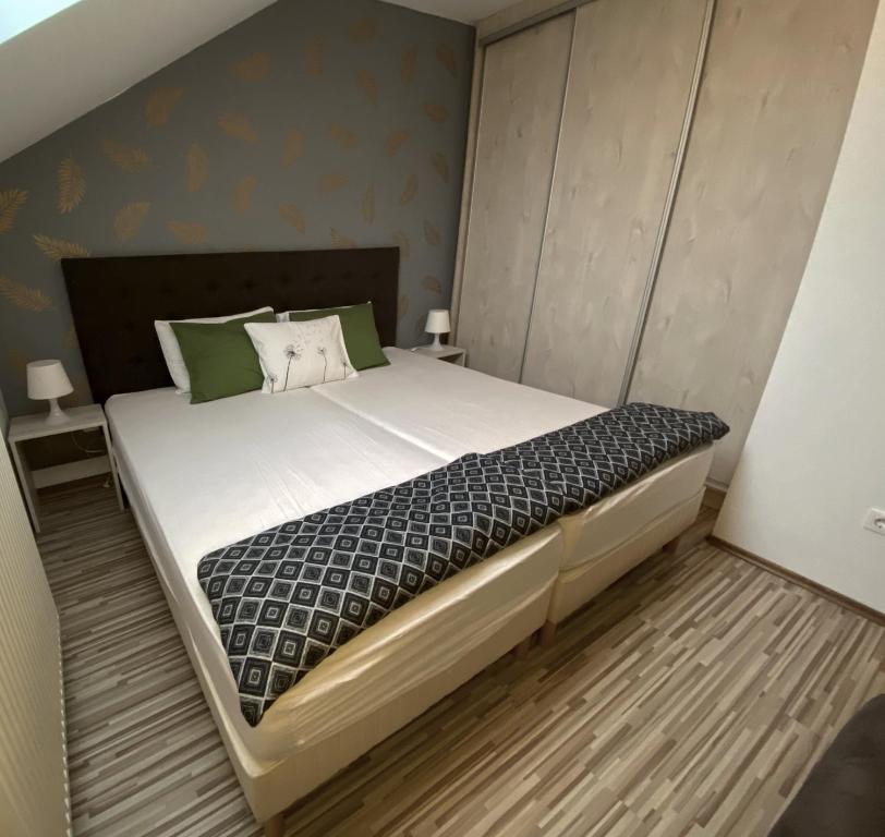 A bed or beds in a room at Bóbita Apartman
