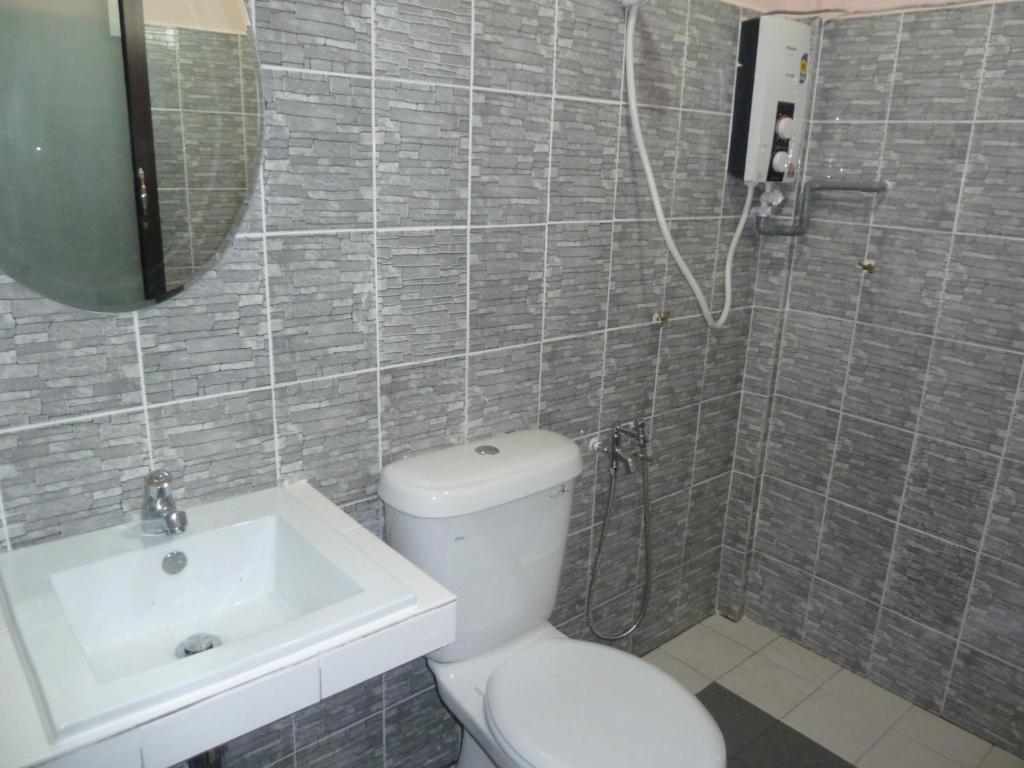 a bathroom with a toilet and a sink at Cempaka Beach Resort in Kuantan