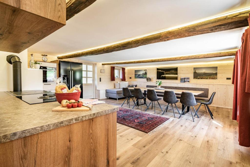 a kitchen and living room with a table and chairs at STAUDACH - Alpinresidenz Zillertal in Ramsau im Zillertal