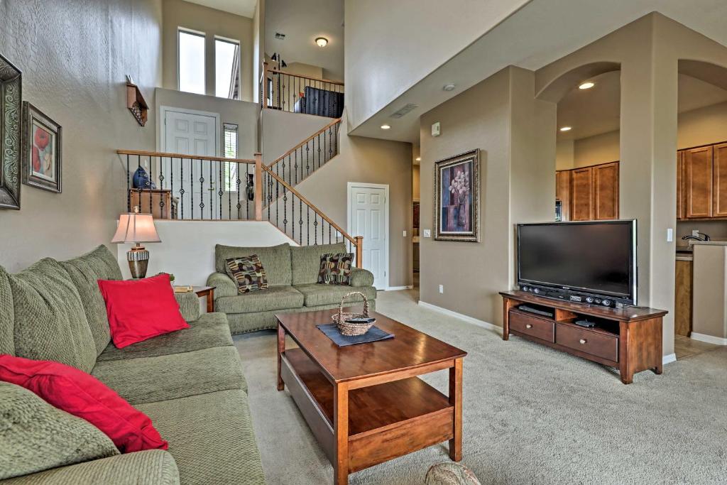 a living room with a couch and a television at Golf Course View and Pool Access Gold Canyon Gem in Gold Canyon