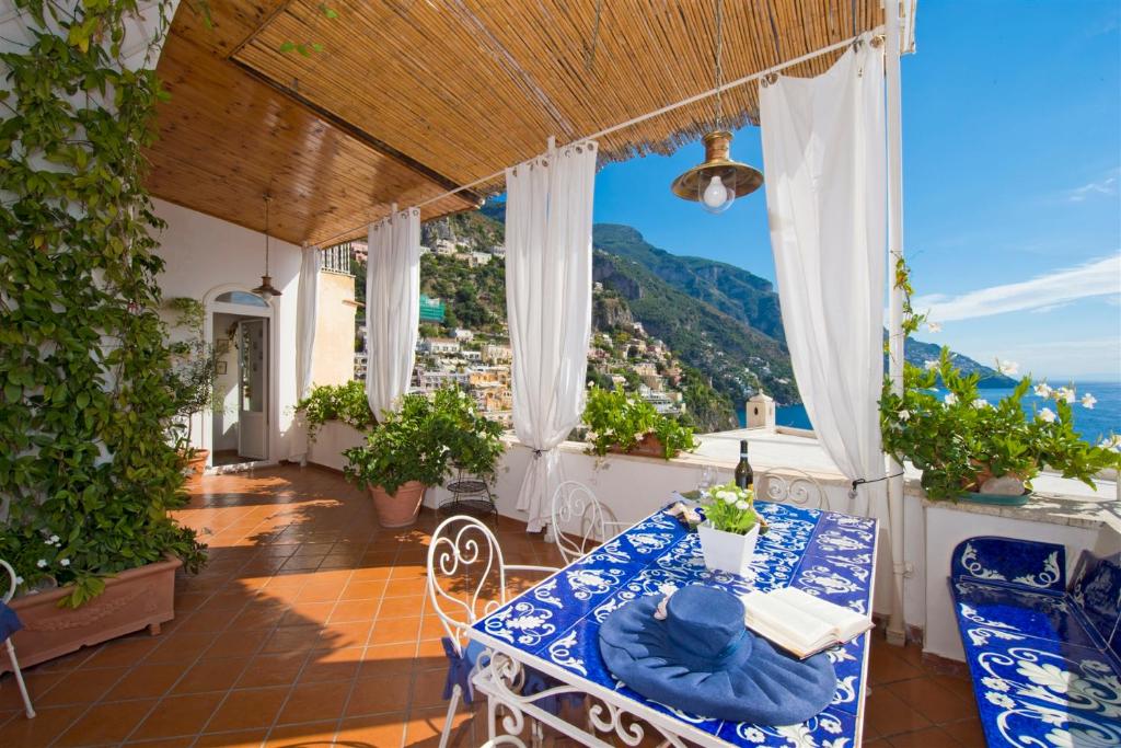 einen Tisch und Stühle auf einem Balkon mit Aussicht in der Unterkunft CASA NOEMI 4&2, Emma Villas in Positano