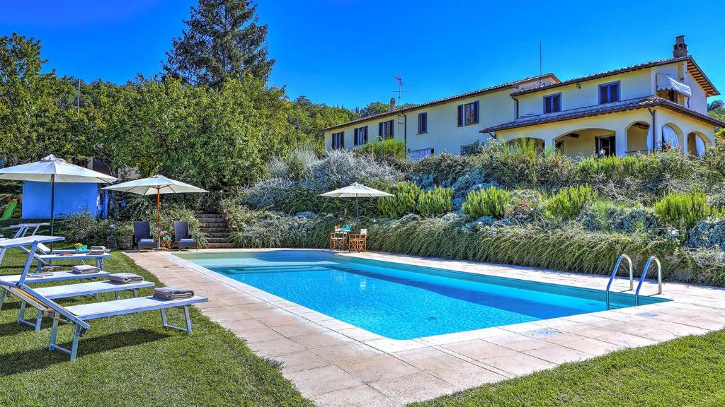 a swimming pool in the yard of a house at CASALE LE CONCE 6, Emma Villas in Castel del Piano