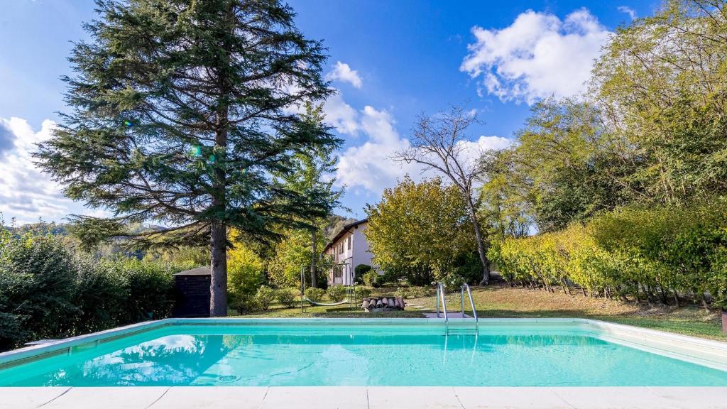 een zwembad in de tuin van een huis bij CASCINA LA VALLE 10&2, Emma Villas in Ozzano Monferrato