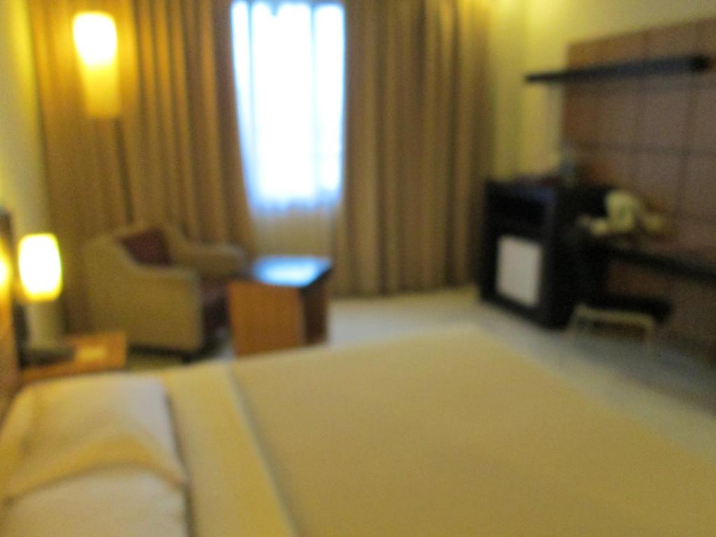 Postel nebo postele na pokoji v ubytování Hotel Kini Pontianak