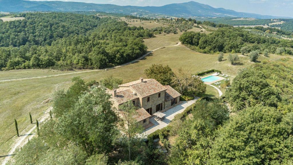 an aerial view of a house on a hill with a pool at PODERE DI SALCI 10, Emma Villas in Città della Pieve
