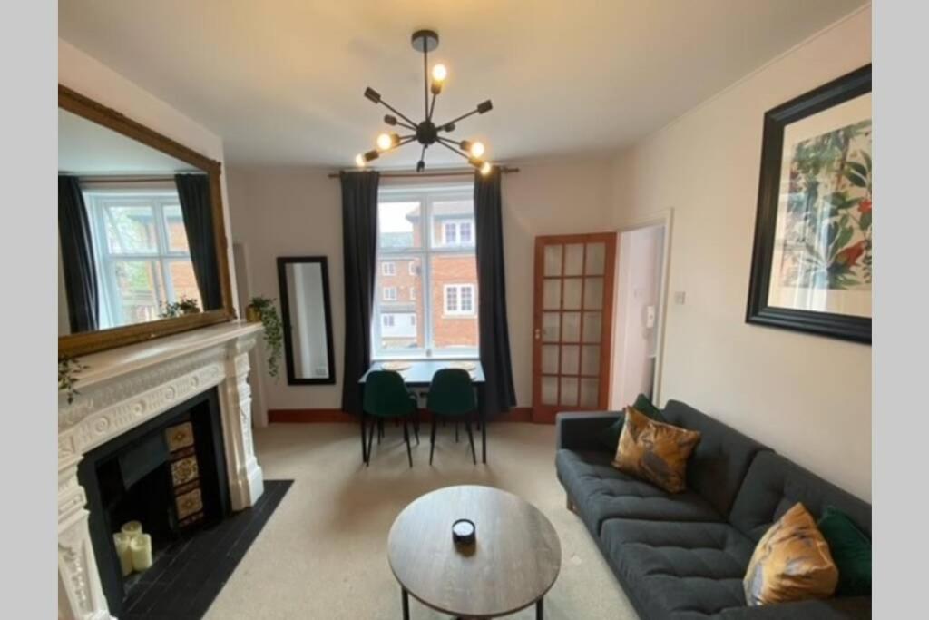 a living room with a couch and a fireplace at City Walls View PERIOD APARTMENT in Chester