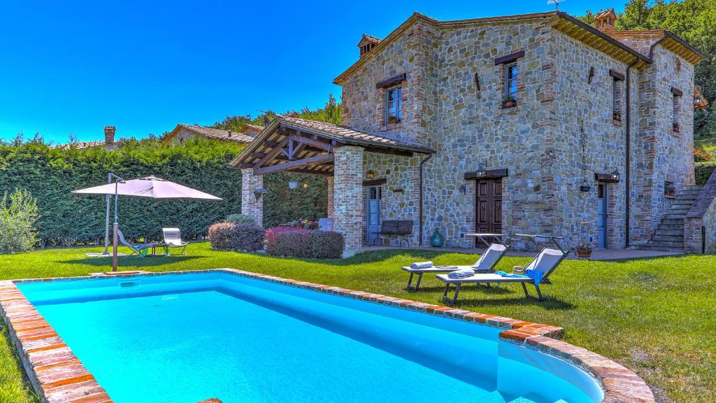 une villa avec une piscine en face d'une maison dans l'établissement San Rocco 4, Emma Villas, à Montecchio