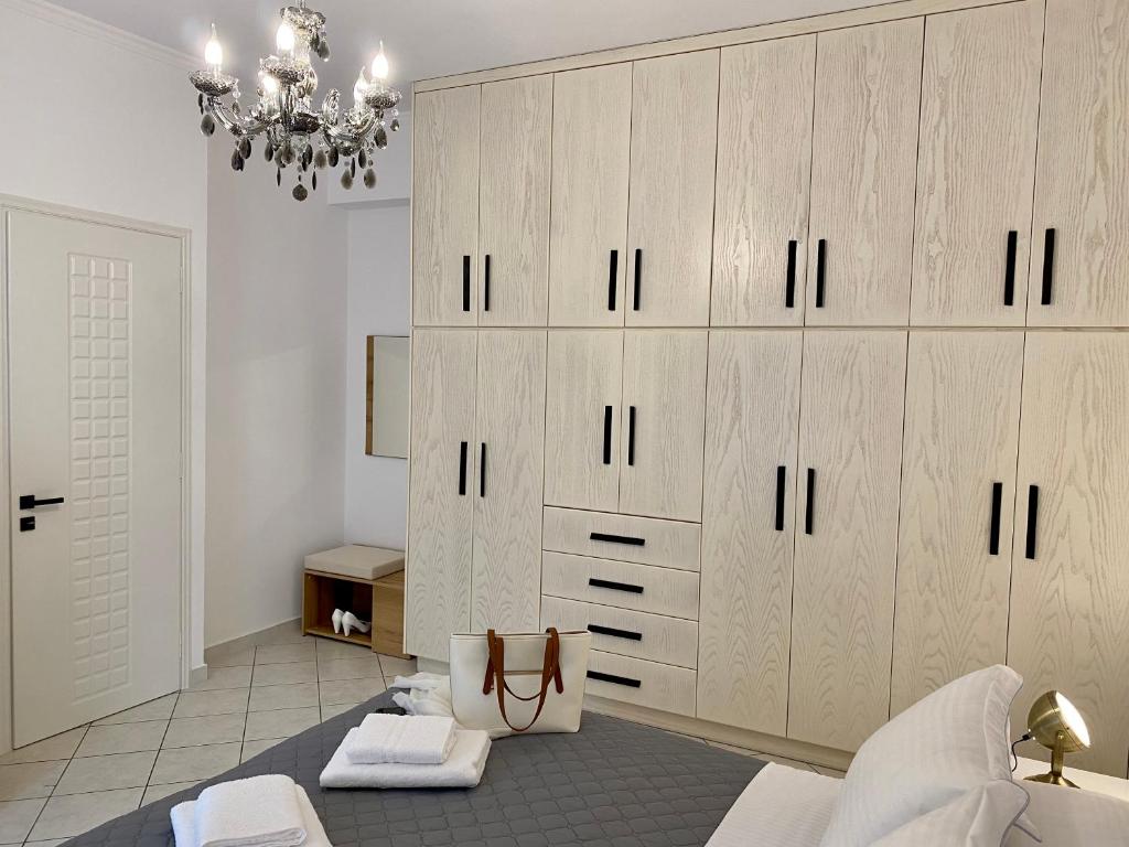 a bedroom with a large closet with wooden cabinets at PORTA HOME modern and hospitable in Naxos Chora