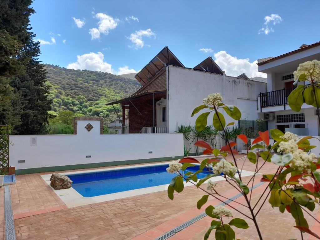 a house with a swimming pool in front of a house at APARTAMENTO ESTACIÓN 54 in Benaoján