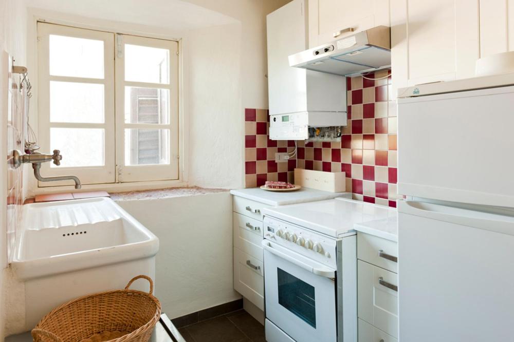 a small kitchen with a sink and a stove at Castello di Rocca Grimalda in Rocca Grimalda
