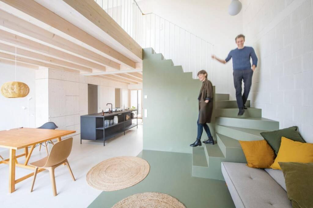 a man walking down the stairs in a living room at STILVOLL und LUFTIG IM HERZEN VON LINZ in Linz