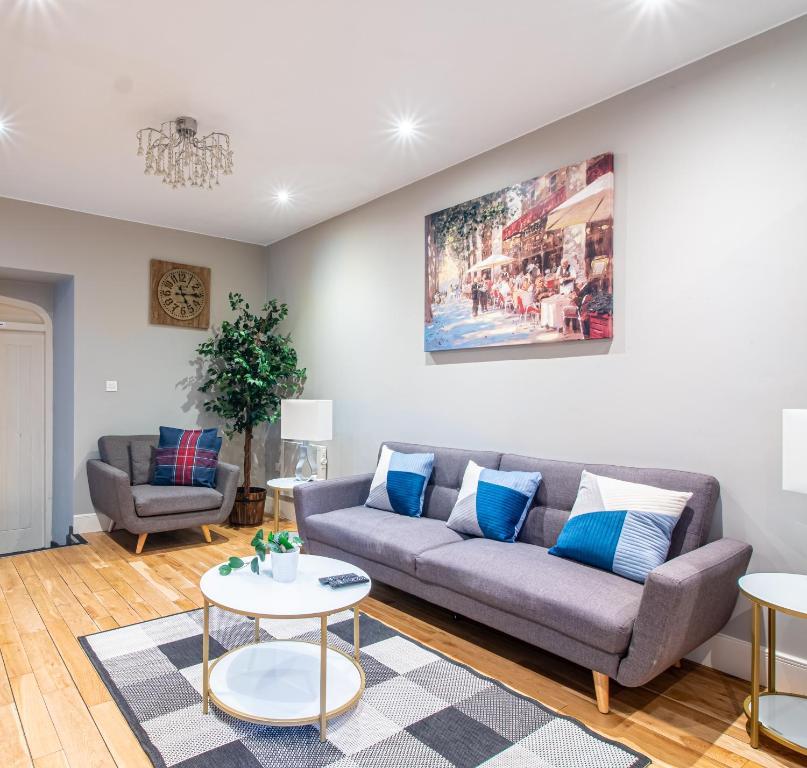 a living room with a couch and a table at AVO Kelham Apartments in Sheffield