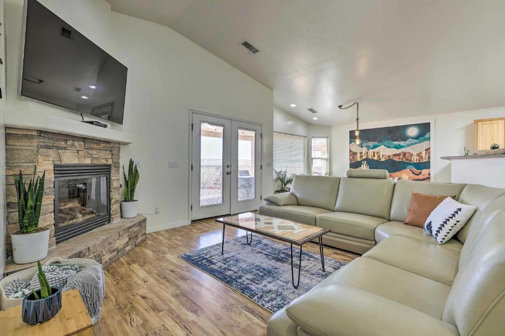 a living room with a couch and a fireplace at Modern Retreat with View, 9 Mi to Wahweap Beach! in Page