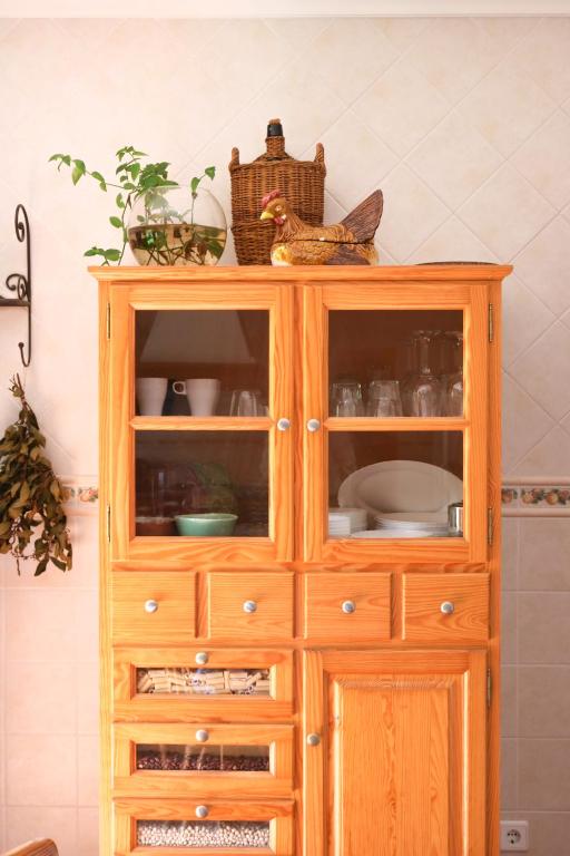 a wooden cabinet with dishes on top of it at Quinta Amarela - B&B in Nazaré