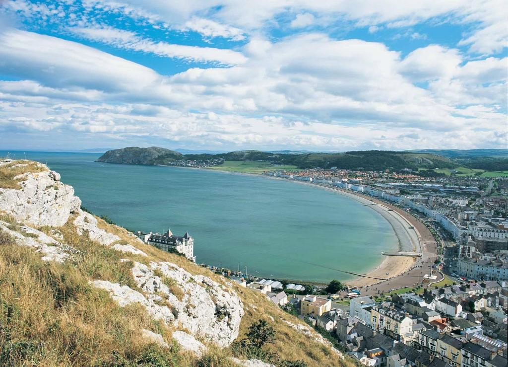 a view of a city and a beach on a hill at No 27 Chapel Street Guest House in Llandudno
