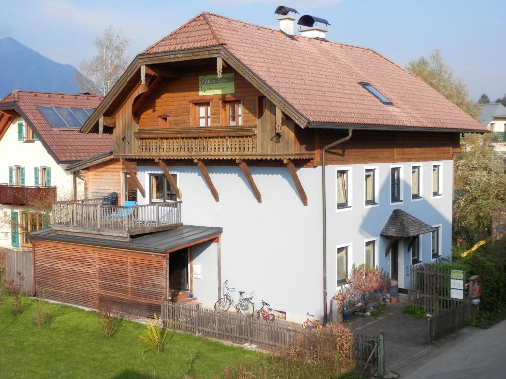 a large wooden house with a balcony at GIRBL bio ZIMMER in Strobl