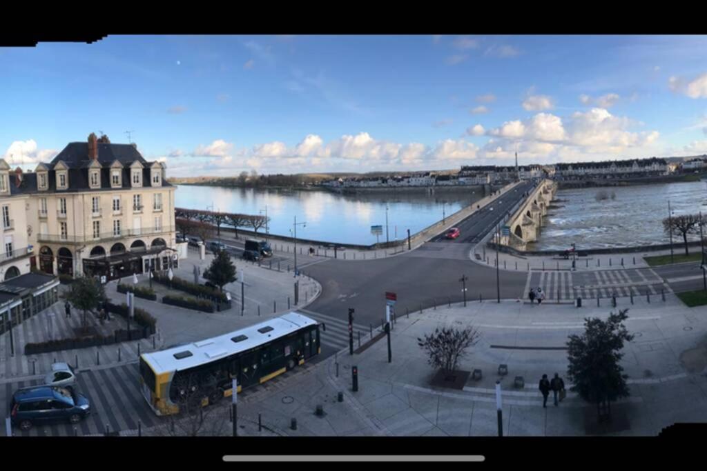 a view of a city with a river and a bus at Les Mansardes du centre ville ,vue Loire in Blois