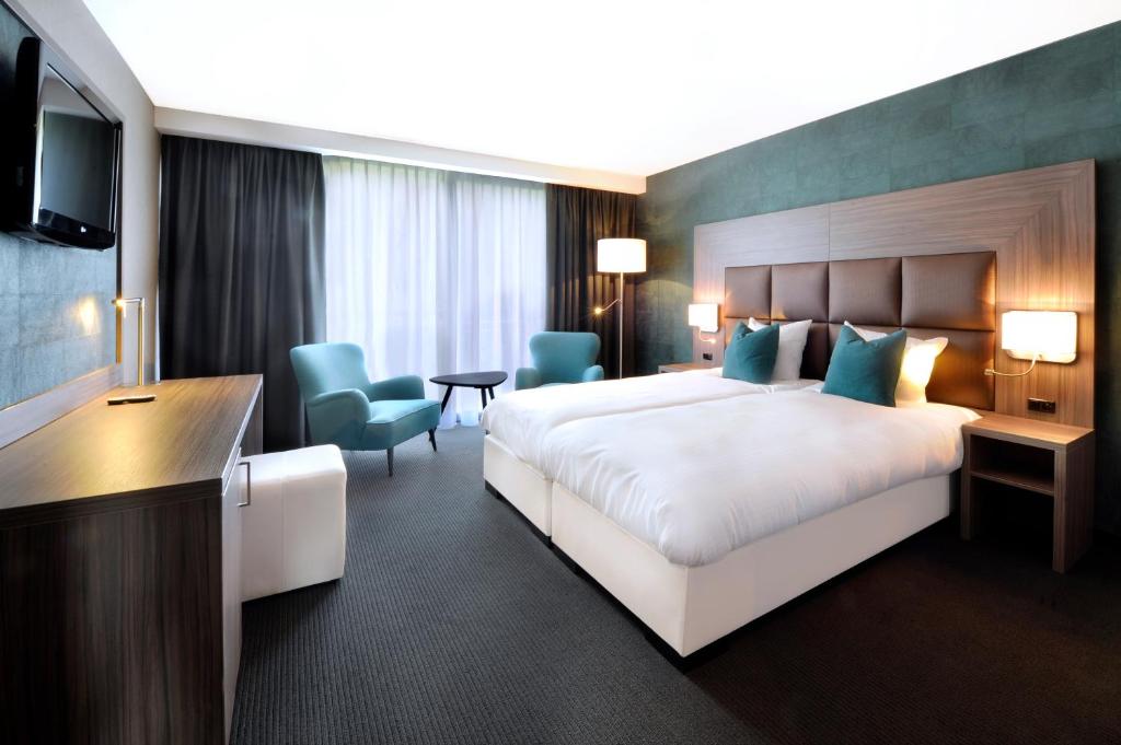 Postel nebo postele na pokoji v ubytování Van der Valk Hotel Nazareth-Gent